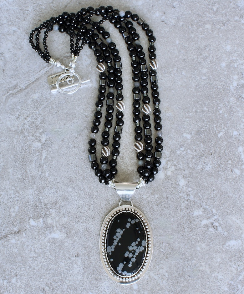 Snowflake Obsidian and Sterling Silver Oval Pendant with 3 Strands of Black Onyx Rounds, Hematite Drum Beads, Hill Tribe Silver Spiral Ovals, and a Hammered Sterling Silver Toggle Clasp