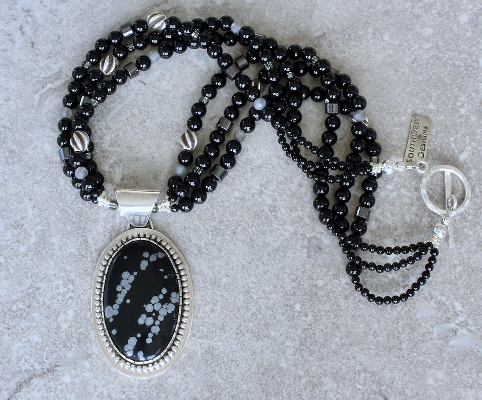 Snowflake Obsidian and Sterling Silver Oval Pendant with 3 Strands of Black Onyx Rounds, Hematite Drum Beads, Hill Tribe Silver Spiral Ovals, and a Hammered Sterling Silver Toggle Clasp